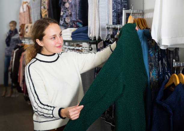 istock Woman choosing new overcoat in store 1092290836