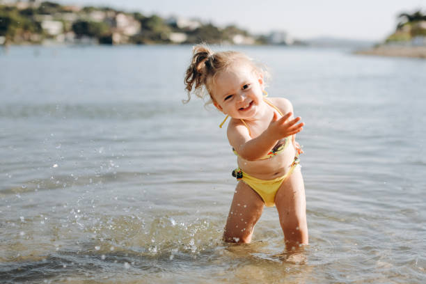 istock Happy laughing toddler girl having fun on sand 1092293280