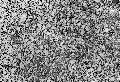 Mechelen, Belgium - 04/20/2018: Black and white picture of grey gravel for dirt roads, cement and construction.