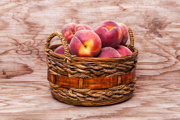 Peach isolated on wooden background.