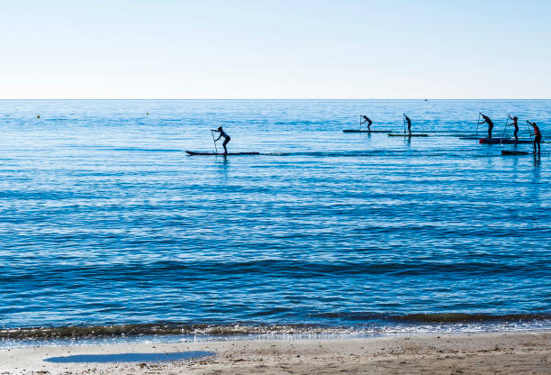 Paddle surf Paddle surfing regatta in the mediterranean sea paddleboard surfing oar water sport stock pictures, royalty-free photos & images