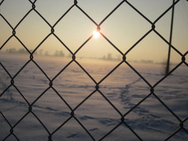 istock Sunlight through the Fence at cold frozen temperature 1092296288