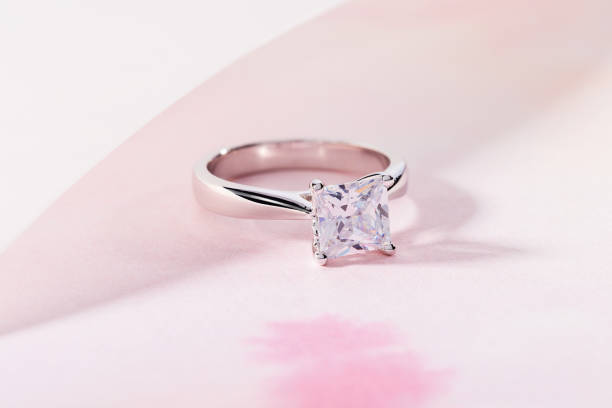 Silver engagement ring with big gemstone Silver engagement ring with big gemstone. Wedding ring with diamond on pink background diamond ring photos stock pictures, royalty-free photos & images