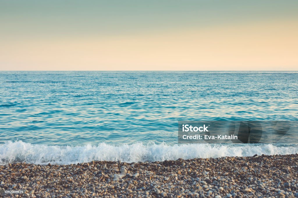 The Mediterranean sea and pebbles stones on a beach in Nice Pebble Stock Photo