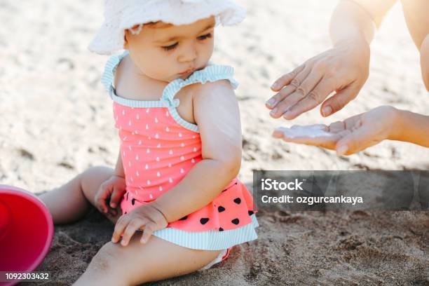 Happy Laughing Toddler Girl Having Fun On Sand Stock Photo - Download Image Now - Suntan Lotion, Baby - Human Age, Child