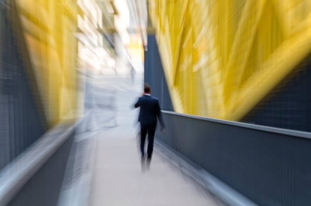 Businessman Walking in Modern Financial District Intentional blurred image of businessman in the city, one person walking in the Financial District, zoom effect, Germany. business architecture blue people stock pictures, royalty-free photos & images