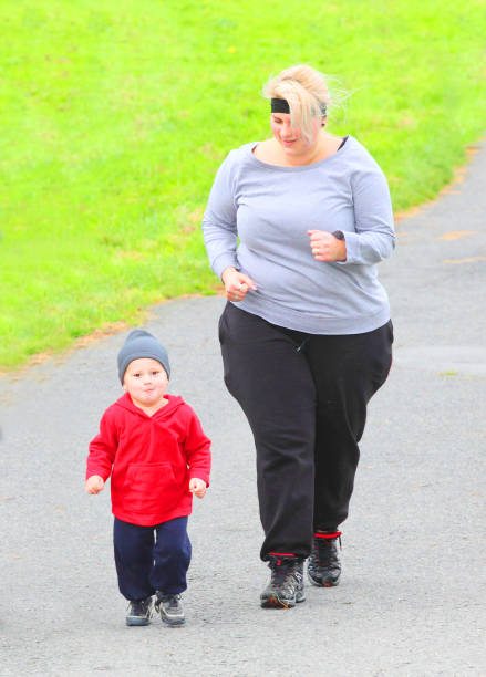istock Overweight parents with her son running together. 1092304196