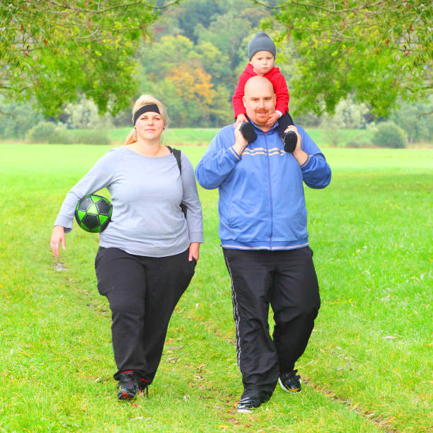 overweight parents with her son running together. - mother exercising baby dieting imagens e fotografias de stock