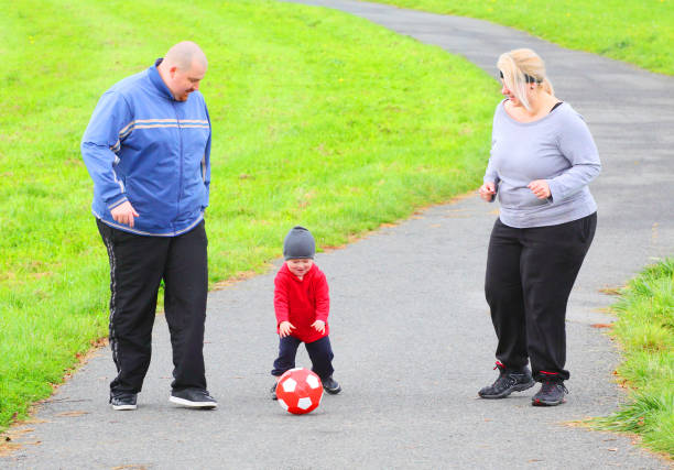 Overweight parents with her son running together. Healthy lifestyle and slimming theme.