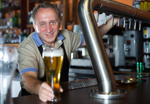 istock Barman is standing with golden beer 1092308964