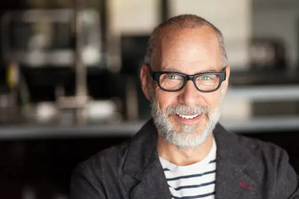 Photo of Portrait Of A Elderly Man Smiling At The Camera