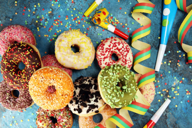 istock assorted donuts with chocolate frosted, pink glazed and sprinkles donuts 1092312282