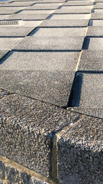 istock Image of checkerboard grey concrete paving slabs, tripping hazard 1092314464