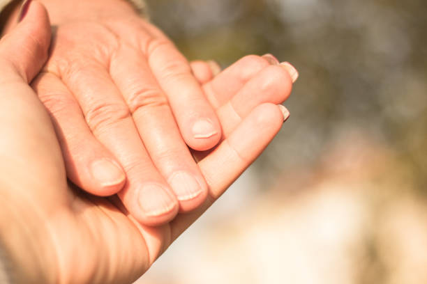 istock Senior and young hands, bokeh background 1092318514
