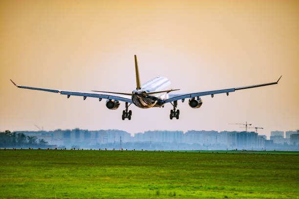istock Landing of the passenger plane at sunset time 1092318748