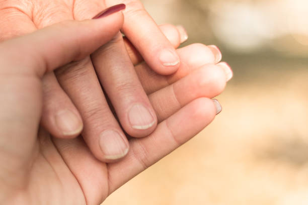 istock Senior and young hands, bokeh background 1092318754