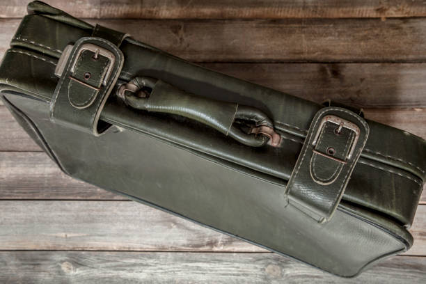 istock Vintage suitcase isolated on wooden background 1092323668