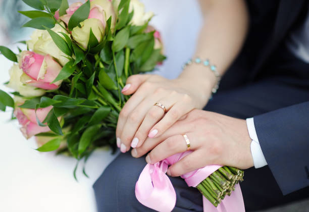 istock Bride and groom's hands with wedding rings 1092324596
