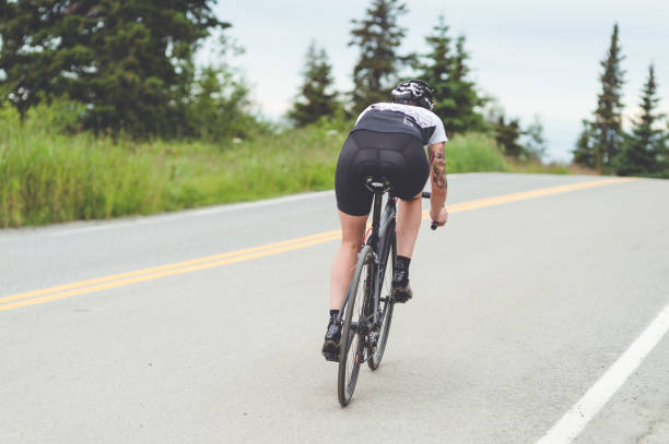 istock Cyclist rides along a rural highway 1092329566