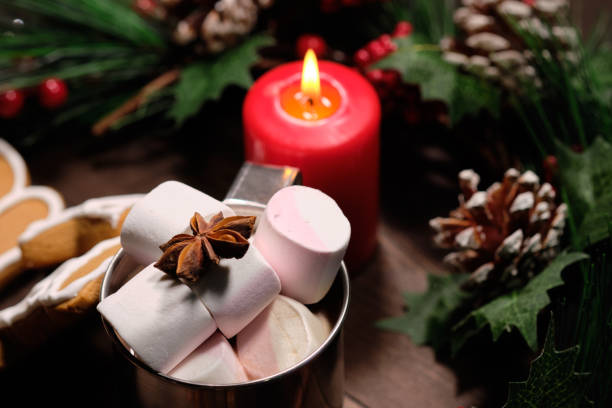 istock ginger biscuit and marshmallows in the iron cup on brown wood background with Christmas tree 1092330408