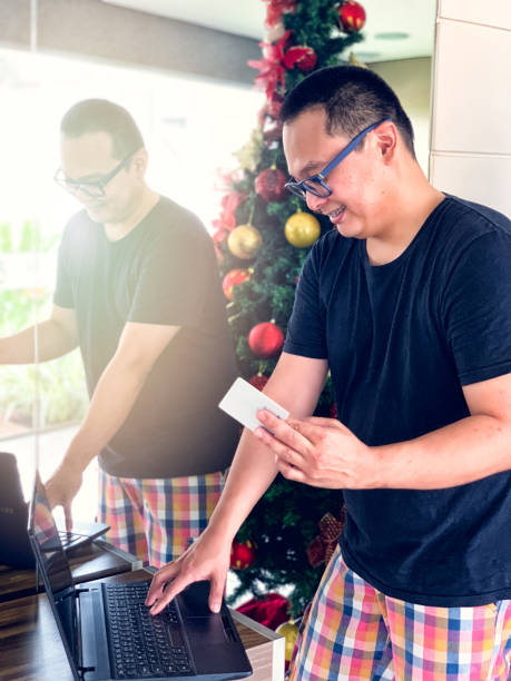 istock Asian man shopping online at Christmas. 1092333224