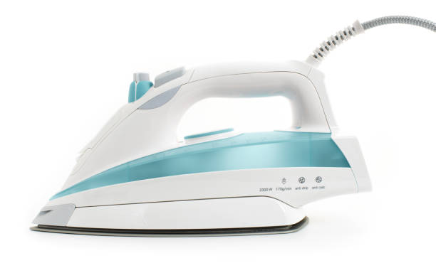 istock Steam iron laid on white background, elegant pastel turquoise model 1092336446