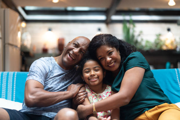 istock Parents and daughter portrait at home 1092338606