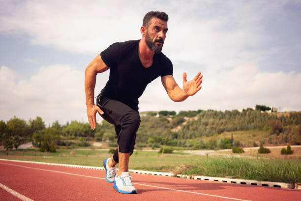 istock Young male athlete training on a race track 1092340220