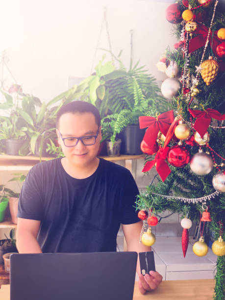 istock Asian man shopping online at Christmas. 1092355170