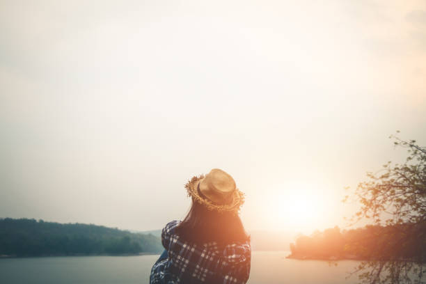 istock Woman Reclining On Rock Against Lake 1092355708