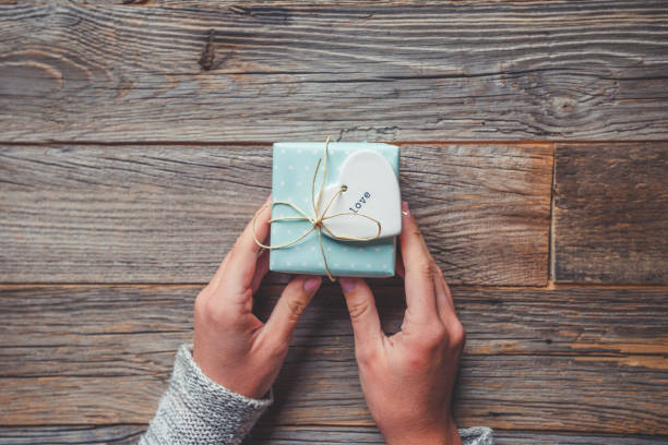 istock Rustic gift box on a wooden table tied with a bow. 1092355974