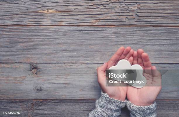 Woman Holding Two White Love Hearts Stock Photo - Download Image Now - Repetition, Gift, Imitation