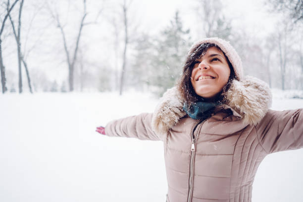 istock Woman spreading hands in a snow covered park 1092360662