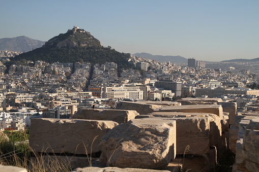 Famous Acropolis and old Parthenon temple is the main landmark of Athens. View of Odeon of Herodes Atticus, Figures of the Caryatid Porch of the Erechtheion.