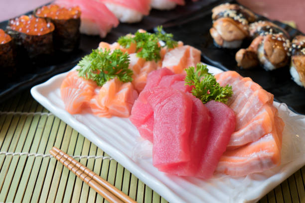 istock Mixed sliced fish sashimi in white plate. Sashimi Salmon and Tuna set with Tuna, flying fish roe caviar and Foie Gras closeup. Japan restaurant menu 1092362254