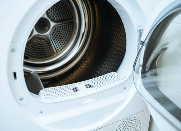 Open door of a modern new front-load clothes dryer Open door of a modern new front-load clothes dryer appliance machine with empty tumble dryer stock pictures, royalty-free photos & images