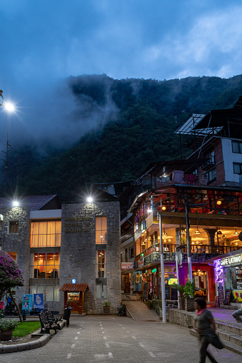Aguas Calientes, Peru - October 16, 2018: Tourists are visiting the street scenery in the evening. Aguas Calientes is the closest town to the ancient Inca city Machu Picchu, it has become a tourist hub for visitors wishing to see the famous landmark.