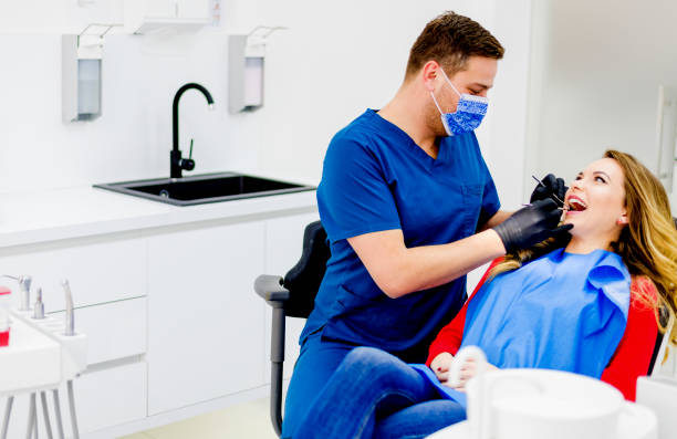 istock Dentist examining woman in clinic 1092378502