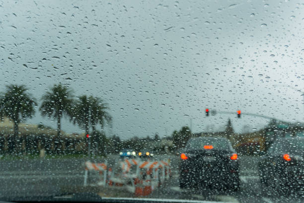 istock Raindrops on the windshield on a rainy day, traffic light background 1092386044