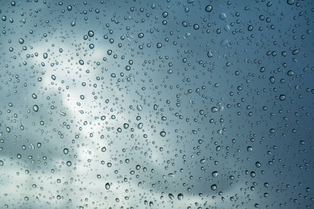 istock Raindrops on the windshield; in the background dark sky and a break in the clouds 1092386152