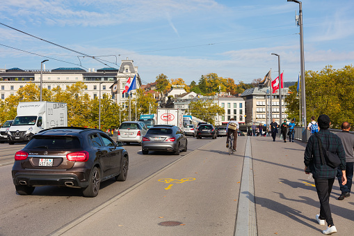 Zurich, Switzerland - September 29, 2017: traffic on the Quaibrucke bridge, view towards Bellevueplatz square. The Quaibrucke bridge is a road, tramway, pedestrian and bicycle bridge over the Limmat river in the city of Zurich.
