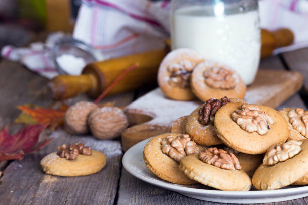 istock gingerbread cookies with walnuts on a table and a cup of milk