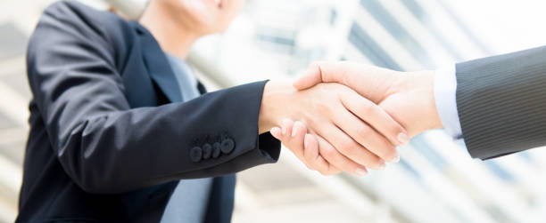 istock Businesswoman making handshake with a businessman 1092392694