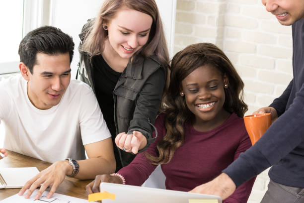 istock Group of mixed race university students working together 1092392834