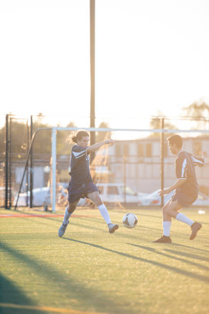 istock Male soccer player dribbling around a defender 1092406898
