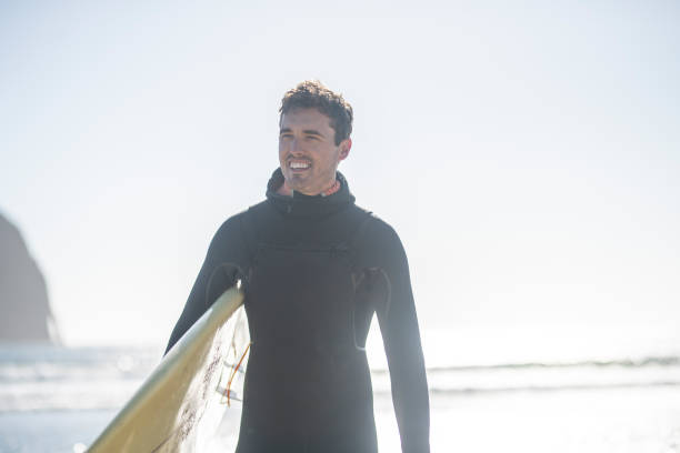 istock A male surfer walking along the beach 1092409172
