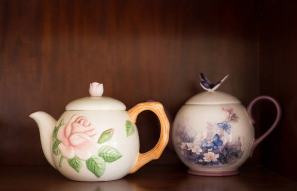 istock Two Vintage Tea Pots on Wooden Shelf 1092412444