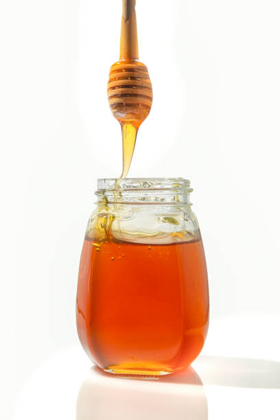 istock Bee honey with a wooden spoon for honey.isolated objects on white background 1092413702