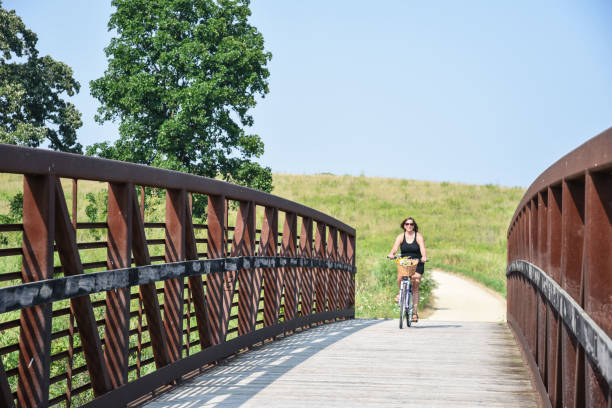 Woman approaching bridge on bike path