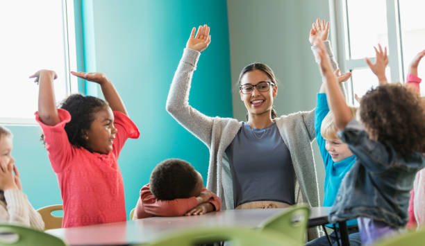 istock Multi-ethnic preschool teacher and students in classroom 1092432126